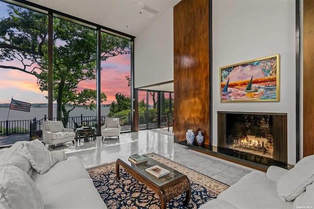 18 Hicks Ln, Sands Point, NY 11050 - living area featuring floor to ceiling windows, a lit fireplace, and plenty of natural light
