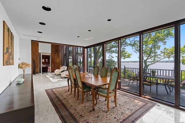 18 Hicks Ln, Sands Point, NY 11050 - dining space with a water view, healthy amount of natural light, a wall of windows, and recessed lighting