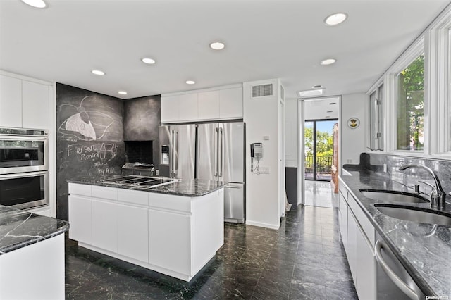 18 Hicks Ln, Sands Point, NY 11050 - kitchen featuring stainless steel appliances, a sink, modern cabinets, dark marble finish flooring, and dark stone counters