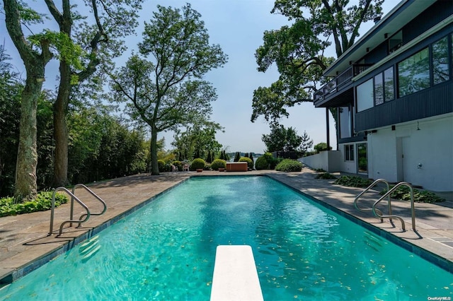 18 Hicks Ln, Sands Point, NY 11050 - outdoor pool with a patio area and a diving board