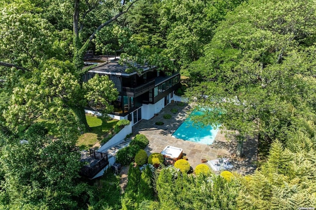 18 Hicks Ln, Sands Point, NY 11050 - view of subject property with a pool area and a heavily wooded area