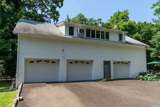 18 Hicks Ln, Sands Point, NY 11050 - view of front of house featuring a garage