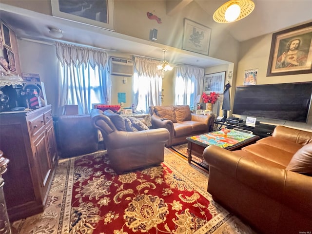 living room with a wall mounted AC, a notable chandelier, and a towering ceiling