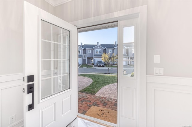 16 Ocean Watch Ct Unit 16, Freeport, NY 11520 - doorway to outside with a wainscoted wall and brick floors