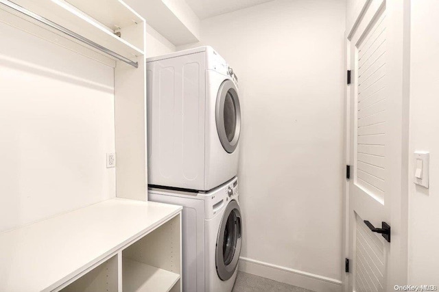 16 Ocean Watch Ct Unit 16, Freeport, NY 11520 - laundry area featuring stacked washer and clothes dryer and baseboards