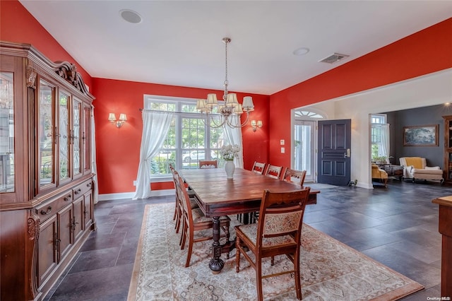 dining area with an inviting chandelier