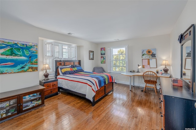 bedroom with hardwood / wood-style flooring