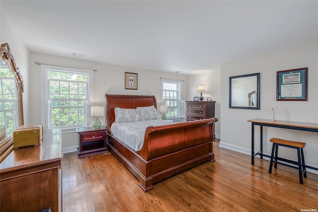 bedroom featuring multiple windows and light wood-type flooring