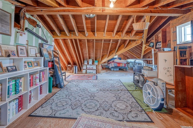 interior space with hardwood / wood-style floors, vaulted ceiling, and wood walls