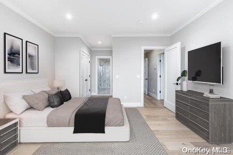 bedroom featuring ensuite bathroom, light hardwood / wood-style flooring, and ornamental molding