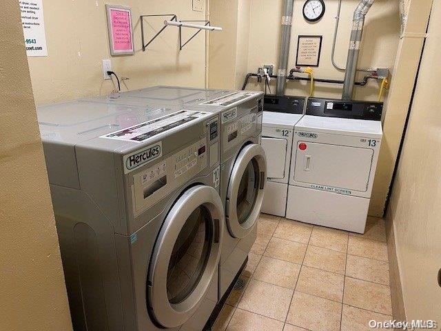 clothes washing area with washer and clothes dryer