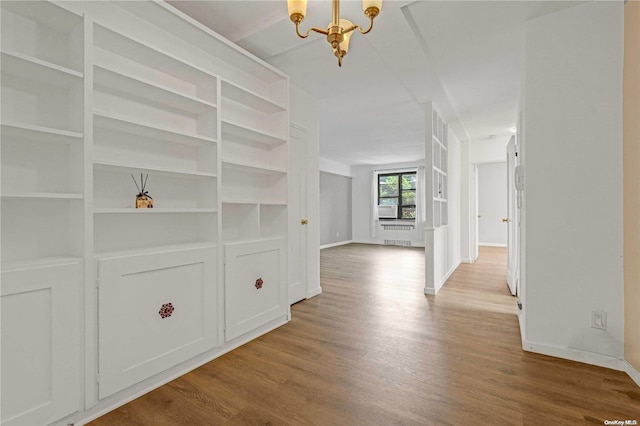 corridor featuring hardwood / wood-style floors and a chandelier