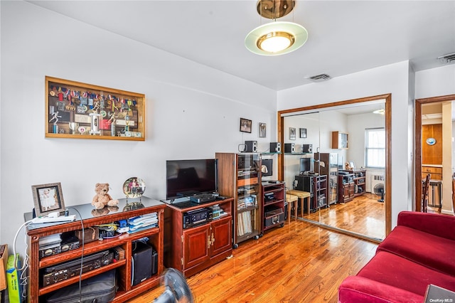 living room featuring wood-type flooring and radiator