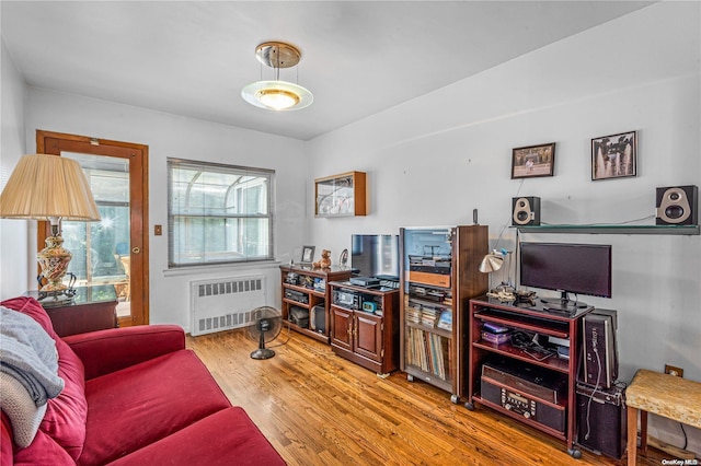 living room with hardwood / wood-style flooring and radiator