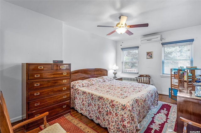 bedroom featuring a wall mounted AC, hardwood / wood-style floors, radiator heating unit, and ceiling fan