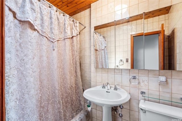 bathroom featuring toilet, tile walls, tasteful backsplash, and walk in shower