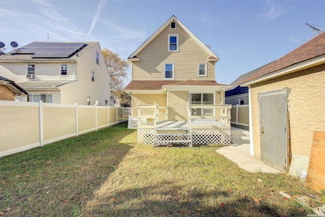 back of house with a yard and a deck