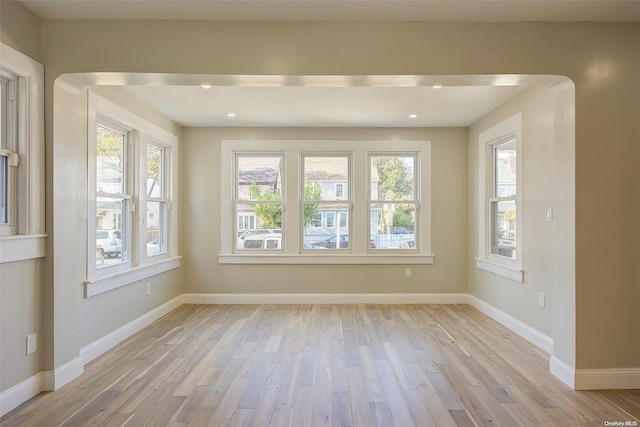 unfurnished room featuring plenty of natural light and light hardwood / wood-style flooring