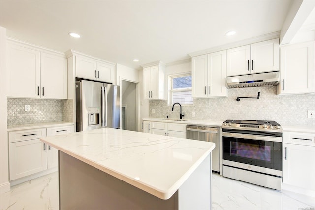 kitchen with sink, a center island, white cabinets, and appliances with stainless steel finishes