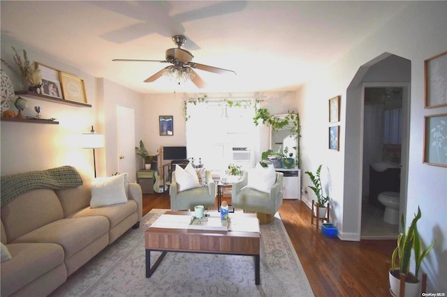 living room with dark hardwood / wood-style floors and ceiling fan