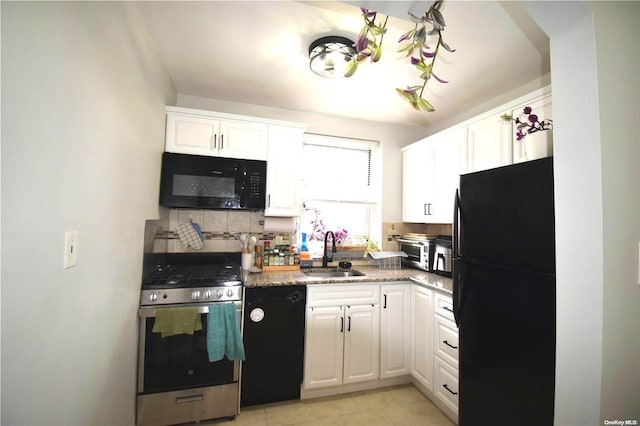 kitchen with backsplash, sink, black appliances, light tile patterned floors, and white cabinets