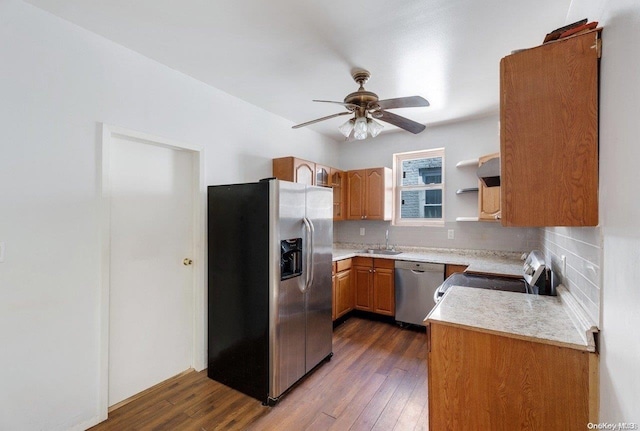 kitchen featuring ceiling fan, sink, tasteful backsplash, dark hardwood / wood-style flooring, and appliances with stainless steel finishes