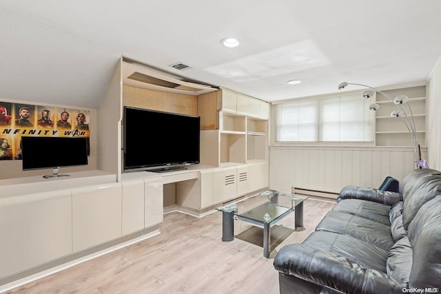 living room featuring light hardwood / wood-style flooring and a baseboard heating unit