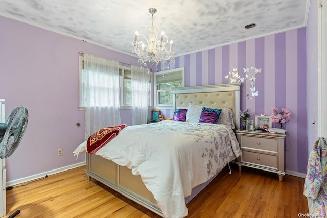 bedroom with wood-type flooring, a textured ceiling, crown molding, and a notable chandelier