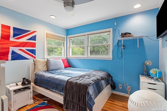 bedroom featuring hardwood / wood-style floors and ceiling fan