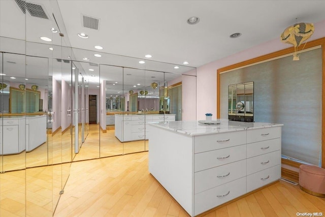 walk in closet featuring light hardwood / wood-style flooring