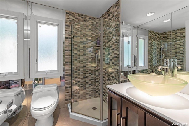 bathroom featuring an enclosed shower, vanity, tile walls, tile patterned flooring, and toilet