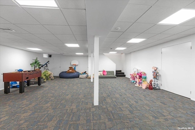 game room featuring a drop ceiling and dark colored carpet