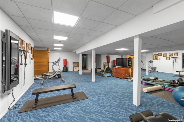 exercise room featuring carpet and a drop ceiling