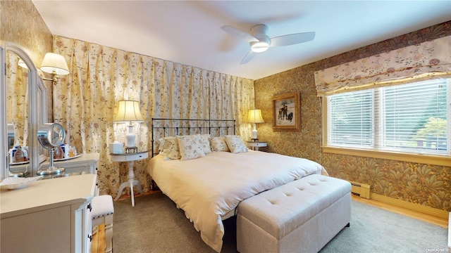 carpeted bedroom with baseboard heating and ceiling fan