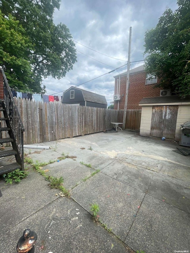 view of yard with a patio and a storage unit