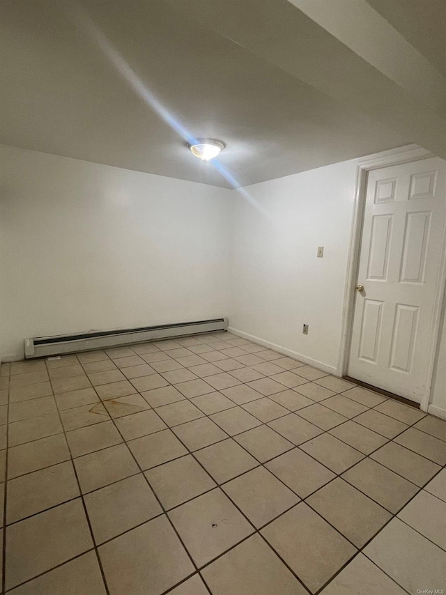 interior space with light tile patterned floors and a baseboard heating unit