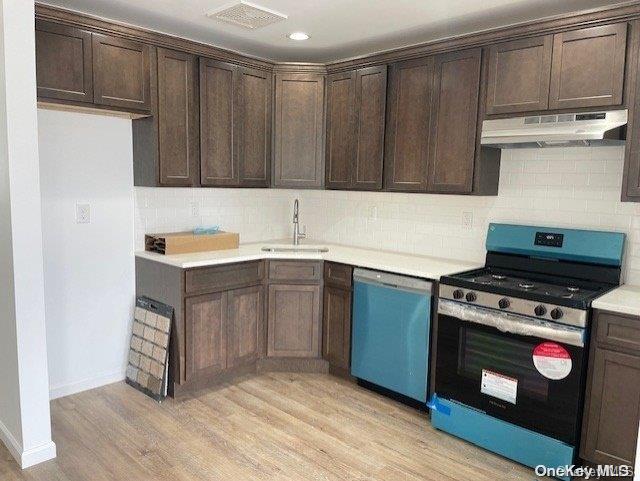 kitchen featuring light hardwood / wood-style floors, sink, appliances with stainless steel finishes, and tasteful backsplash