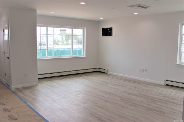 spare room featuring light hardwood / wood-style flooring and a baseboard heating unit