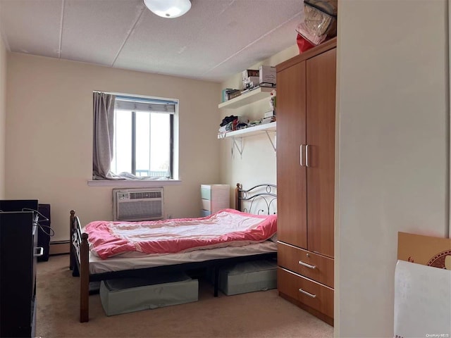 bedroom with light colored carpet, baseboard heating, and a wall mounted AC