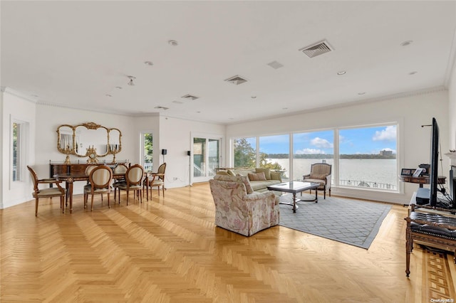 living room featuring crown molding, a healthy amount of sunlight, and light parquet flooring