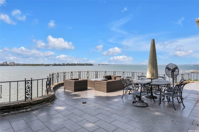 view of patio with outdoor lounge area and a water view