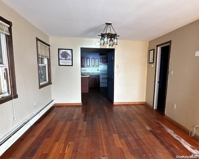 unfurnished dining area featuring a chandelier, a baseboard radiator, dark wood-type flooring, and sink