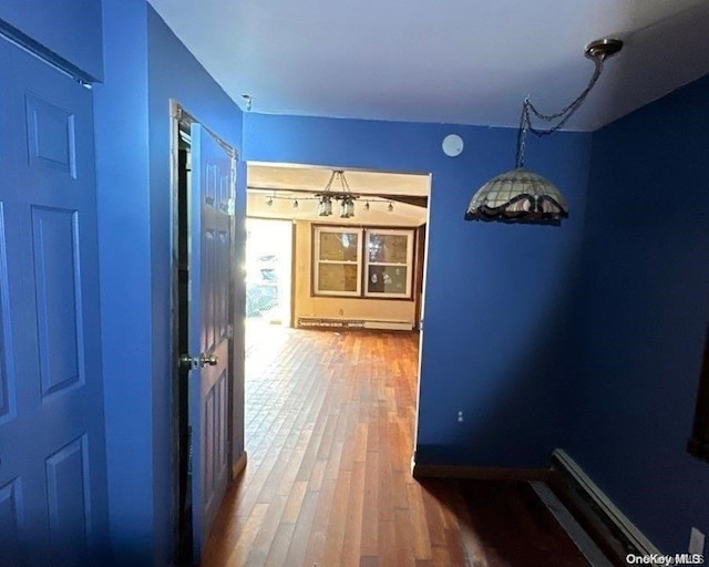 802 Lanark Rd, Broad Channel, NY 11693 - hall with wood finished floors and a baseboard heating unit