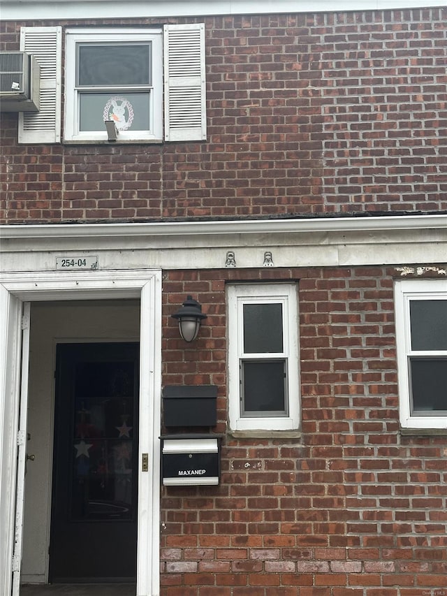 property entrance with brick siding