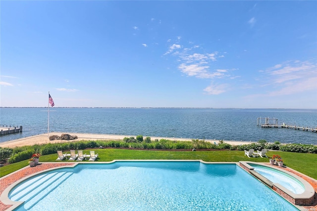 view of swimming pool featuring an in ground hot tub, a boat dock, a yard, and a water view