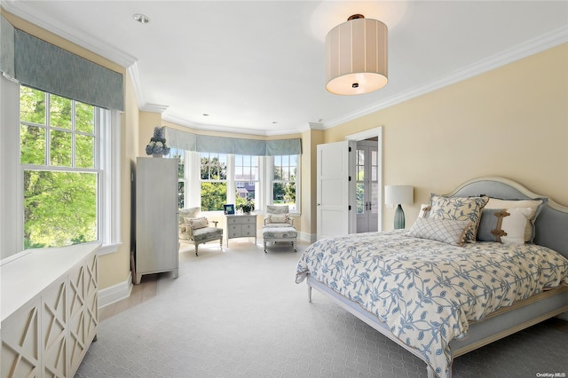 bedroom featuring carpet, ornamental molding, and multiple windows