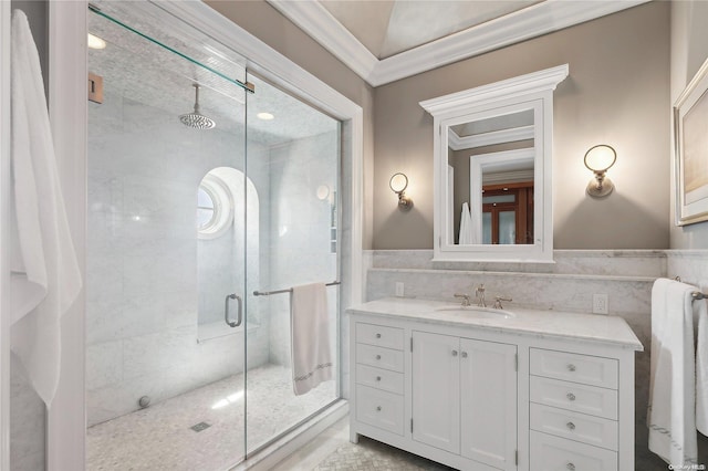 bathroom featuring vanity, a shower with shower door, crown molding, and tile walls