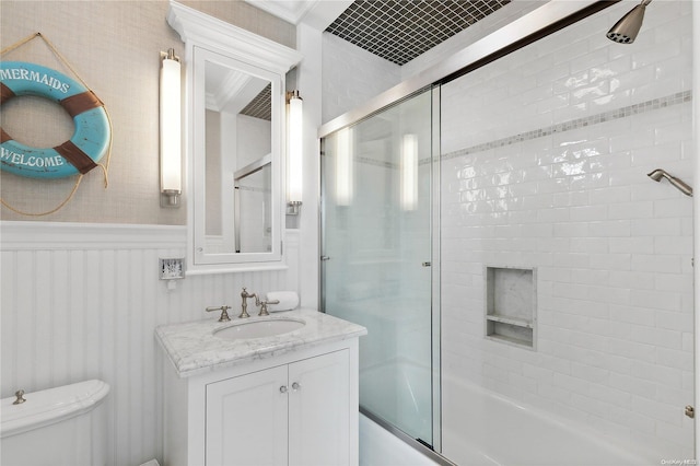 full bathroom with vanity, toilet, and enclosed tub / shower combo