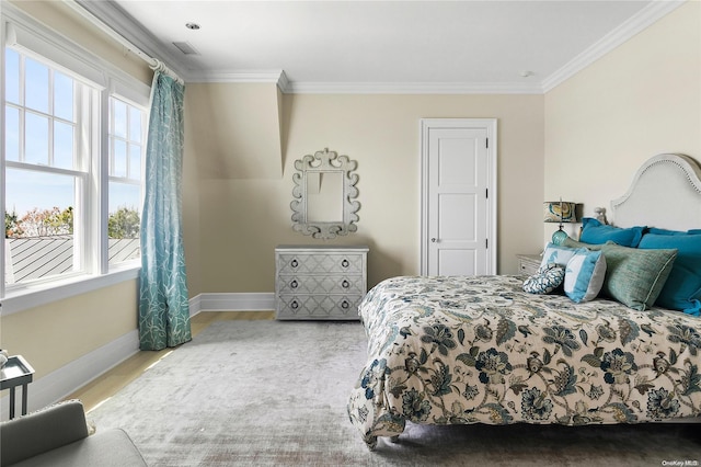 bedroom featuring wood-type flooring and ornamental molding