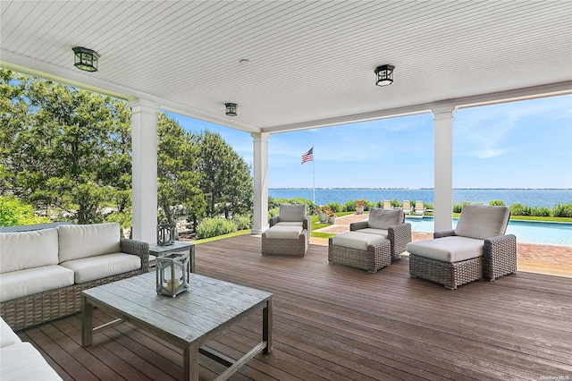 wooden deck featuring outdoor lounge area and a water view